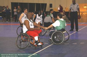 Men playing wheelchair basketball.